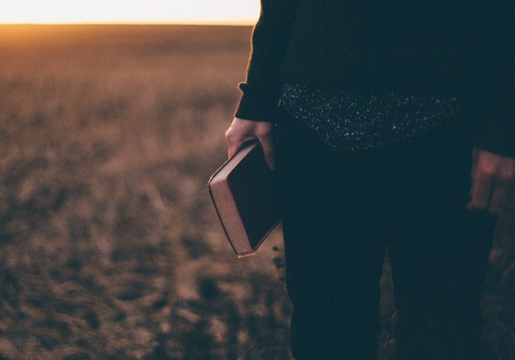 christian preaching holding a bible